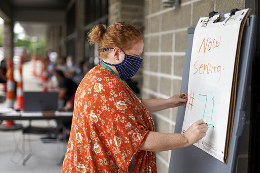 FILE - In this July 15, 2020, file photo, one-stop operator Vickie Gregorio with the Heartland Workforce Solutions updates a whiteboard outside the workforce office in Omaha, Neb., as those seeking employment await their turn outside. The Labor Department reported unemployment numbers Thursday, Sept. 3. (AP Photo/Nati Harnik, File) PHOTO CREDIT: Nati Harnik