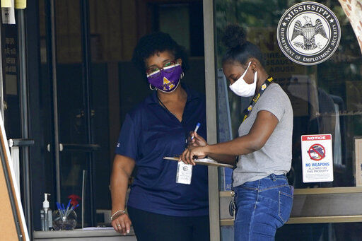 An employee of the Mississippi Department of Employment Security WIN Job Center in Pearl, Miss., left, assists a client fill out paperwork, Monday, Aug. 31, 2020. The Labor Department reported unemployment numbers Thursday, Sept. 3. (AP Photo/Rogelio V. Solis, File) PHOTO CREDIT: Rogelio V. Solis
