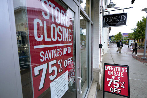 Passersby walk past a business storefront with store closing and sale signs, Wednesday, Sept. 2, 2020, in Dedham, Mass. The number of people seeking U.S. unemployment aid rose slightly to 870,000, a historically high figure that shows that the viral pandemic is still squeezing restaurants, airlines, hotels and many other businesses six months after it first erupted. (AP Photo/Steven Senne) PHOTO CREDIT: Steven Senne