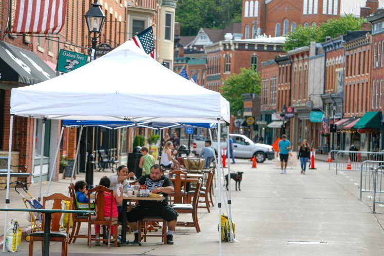 People enjoy the outdoor seating outside bars and restaurants on South Main Street in Galena, Ill., in May.  PHOTO CREDIT: Dave Kettering