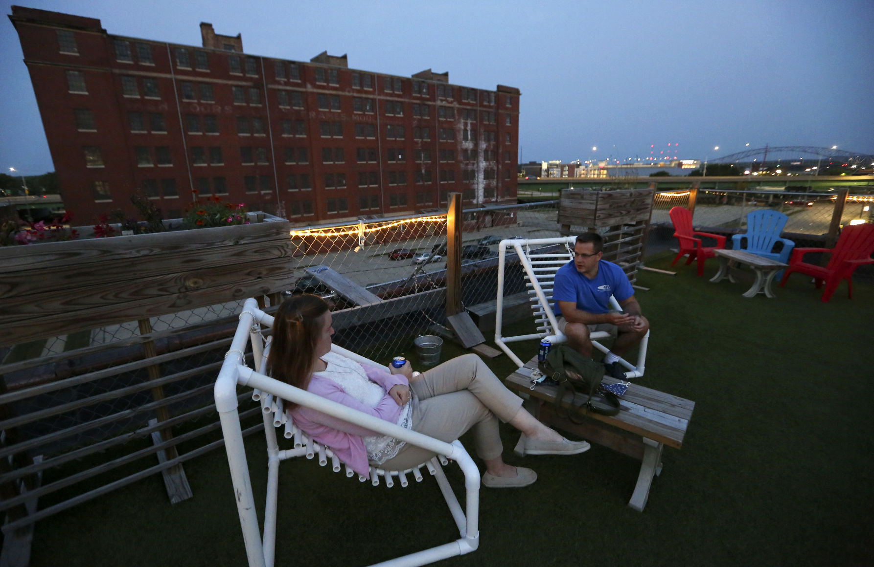 Tara (left) and Nick Baker, of Dubuque, hang out on the rooftop at Smokestack in Dubuque on Friday, Sept. 25, 2020. PHOTO CREDIT: NICKI KOHL