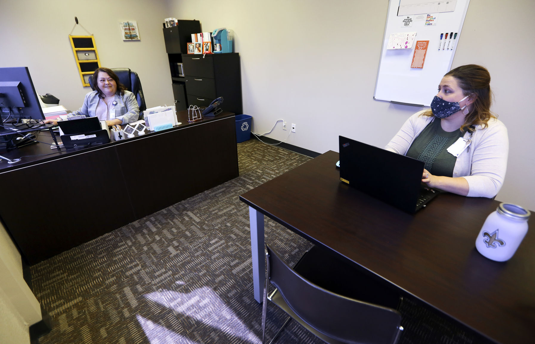 Stacey Killian (left) works with Brittany Hubanks at Visiting Nurse Association in Dubuque. PHOTO CREDIT: Nicki Kohl/Telegraph Herald