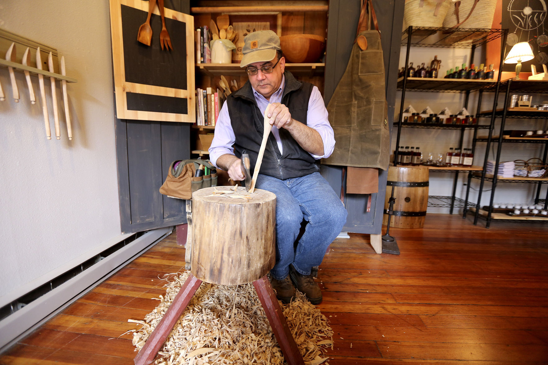 Paul Pendola, owner of Galena Spoon Co., demonstrates how a wooden spoon is carved at his store. PHOTO CREDIT: Dave Kettering