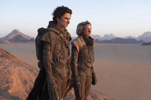 Timothee Chalamet (left) and Rebecca Ferguson appear in a scene from "Dune." Warner Bros. said late Monday that “Dune” will now open in October 2021, instead of this December.  PHOTO CREDIT: Chia Bella James