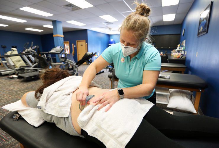 Physical Therapist Assistant Emily Funke treats a patient at Unified Therapy Services in Dubuque. Area physical therapy clinics have expressed major concerns about a proposed cut to Medicare reimbursement. PHOTO CREDIT: NICKI KOHL