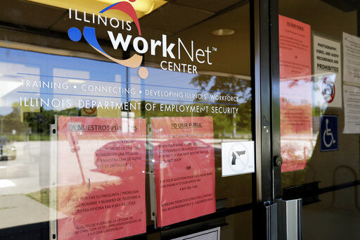 FILE - In this June 11, 2020, file photo, information signs are displayed at the closed Illinois Department of Employment Security WorkNet center in Arlington Heights, Ill. U.S. employers advertised for slightly fewer jobs in August while their hiring ticked up modestly. The Labor Department said Tuesday, Oct. 6, 2020, that the number of U.S. job postings on the last day of August dipped to 6.49 million, down from 6.70 million July. (AP Photo/Nam Y. Huh, File) PHOTO CREDIT: Nam Y. Huh