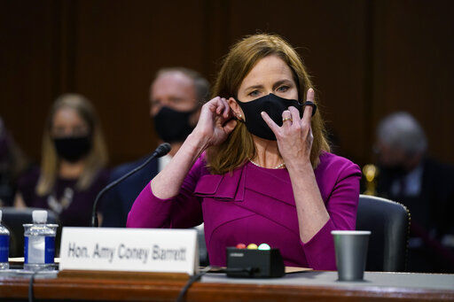 Supreme Court nominee Amy Coney Barrett removes her mask to speak during a confirmation hearing before the Senate Judiciary Committee, Monday, Oct. 12, 2020, on Capitol Hill in Washington. (AP Photo/Patrick Semansky, Pool) PHOTO CREDIT: Patrick Semansky