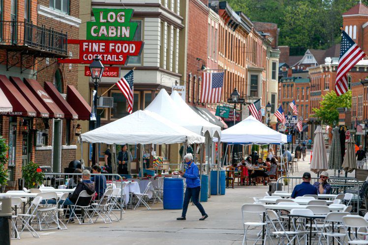 People enjoy the seating outside bars and restaurants on Main Street Galena, Ill. PHOTO CREDIT: TH file