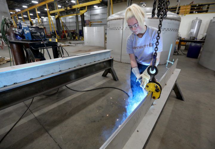 Vic Bode tack welds a stainless steel beam at Unison Solutions in Dubuque on Wednesday. Bode, a senior at Dubuque Senior High School, is in a welding apprenticeship offered through Dubuque Community Schools. PHOTO CREDIT: JESSICA REILLY