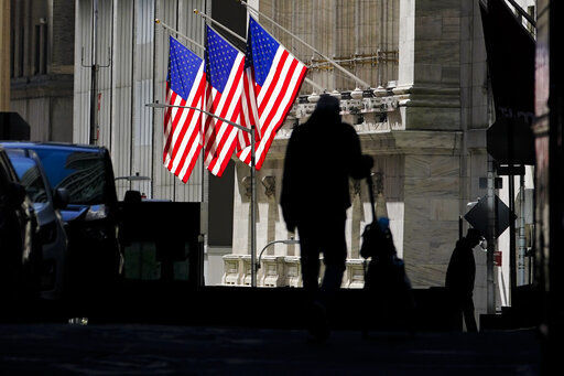 FILE - In this Oct. 14, 2020 file photo, pedestrians pass the New York Stock Exchange in New York. Stocks are opening higher on Wall Street Tuesday, Oct. 20 as traders look over several solid earnings reports from U.S. companies. (AP Photo/Frank Franklin II, File) PHOTO CREDIT: Frank Franklin II