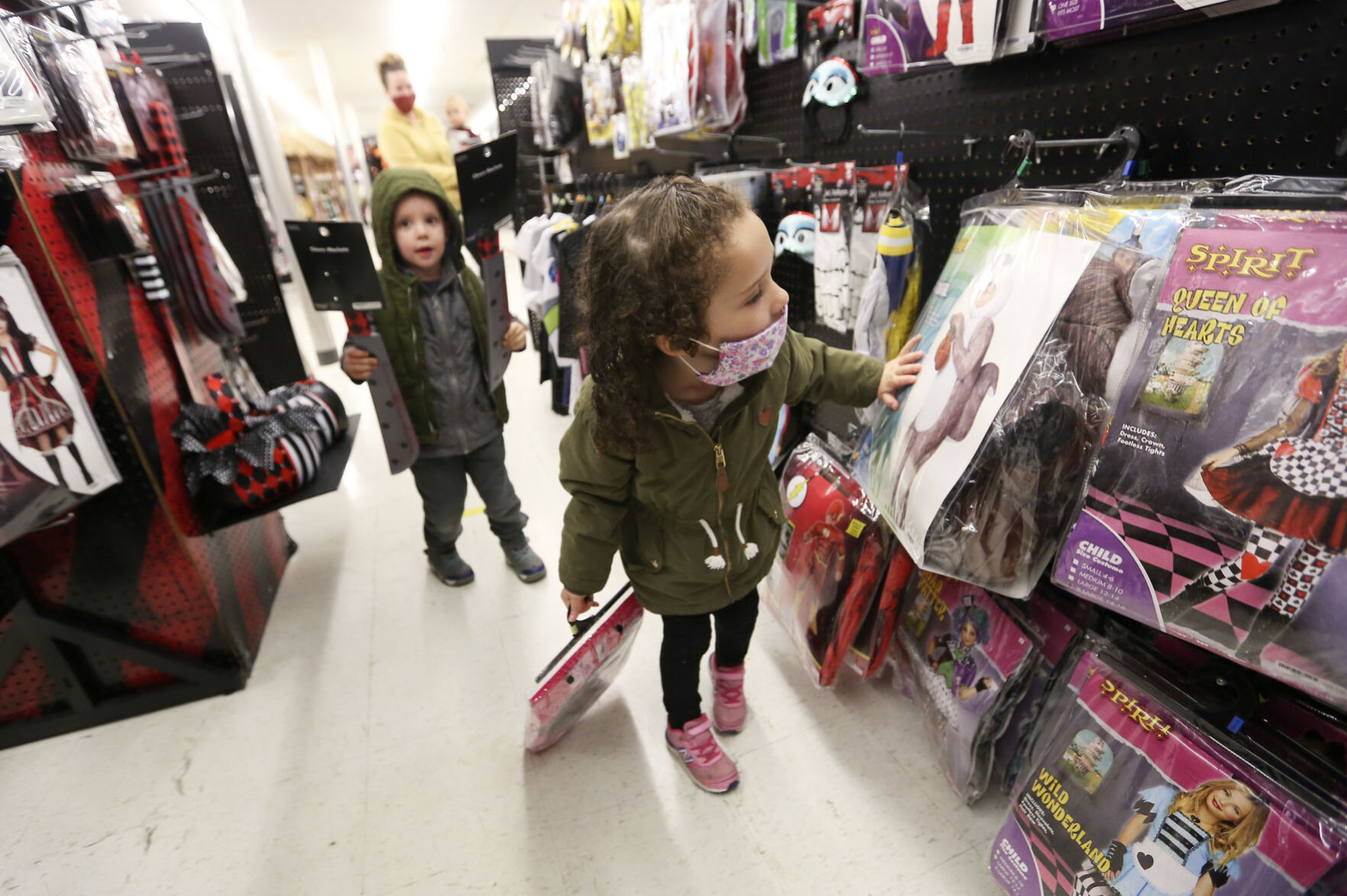 Evelyn Johnson, 3, of Dyersville, Iowa, browses costumes at Spirit Halloween in Dubuque on Tuesday, Oct. 20, 2020. PHOTO CREDIT: NICKI KOHL
