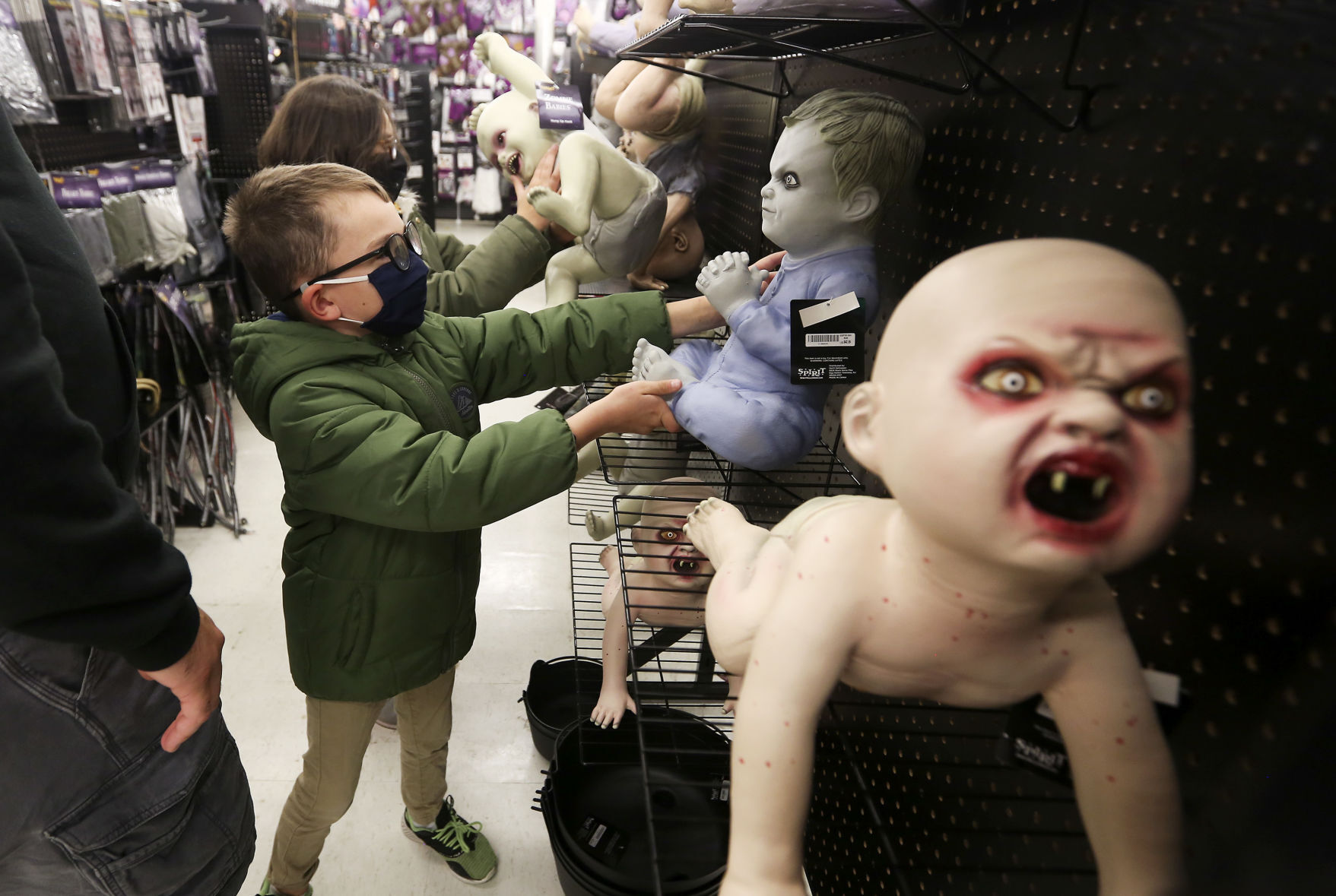Charlie Huff (front), 7, and Ella Huff, 9, of Dubuque, check out displays while shopping at Spirit Halloween in Dubuque on Tuesday, Oct. 20, 2020. PHOTO CREDIT: NICKI KOHL