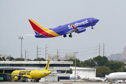 A Southwest Airlines Boeing 737-7H4 takes off, Tuesday, Oct. 20, 2020, from Fort Lauderdale-Hollywood International Airport in Fort Lauderdale, Fla. Airlines are continuing to pile up billions of dollars in losses as the pandemic causes a massive drop in air travel. Southwest Airlines on Thursday, Oct. 22, lost $1.16 billion in the normally strong third quarter, which includes most of the summer vacation season.(AP Photo/Wilfredo Lee) PHOTO CREDIT: Wilfredo Lee