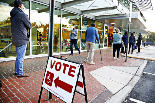 A steady line of voters wait outside of Cameron Village Library in Raleigh, N.C. early Tuesday morning, Nov. 3, 2020, to cast their ballot on Election Day. (Juli Leonard/The News & Observer via AP) PHOTO CREDIT: Juli Leonard