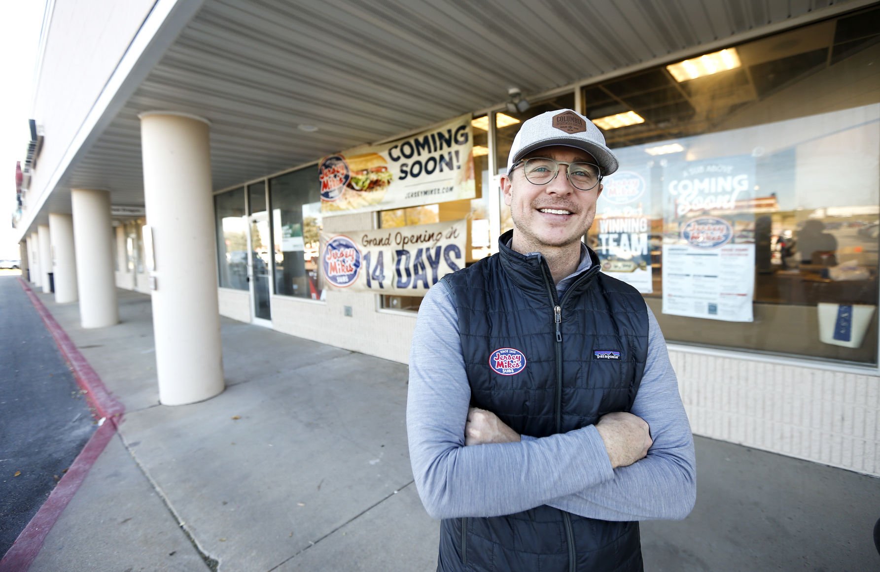 Aron Lees, co-owner of Jersey Mike’s Subs, stands in front of the business located in Warren Plaza in Dubuque. PHOTO CREDIT: Dave Kettering