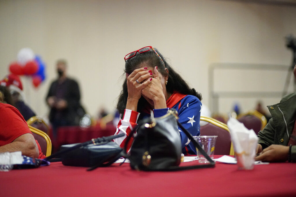 President Donald Trump supporter Loretta Oakes reacts while watching returns in favor of Democratic presidential candidate former Vice President Joe Biden in Las Vegas. With a bitterly divided America failing to deliver a decisive result for either party, a jittery public awaited clarity today over the fate of a race that remained too early to call. PHOTO CREDIT: John Locher