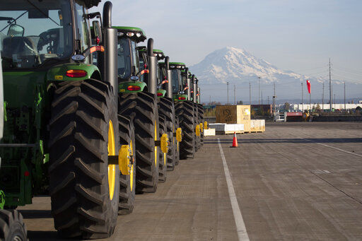 FILE - In this Nov. 4, 2019 file photo, John Deere tractors made by Deere & Company are shown as they are readied for export to Asia at the Port of Tacoma in Tacoma, Wash. The U.S. trade deficit fell in September 2020 after hitting a 14-year high in August as exports outpaced imports. The Commerce Department reported, Wednesday, Nov. 4, 2020, the gap between what the U.S. sells and what it buys abroad fell to 63.9 billion in September, a decline of 4.7% from a $67 billion deficit in August. (AP Photo/Ted S. Warren, File) PHOTO CREDIT: Ted S. Warren