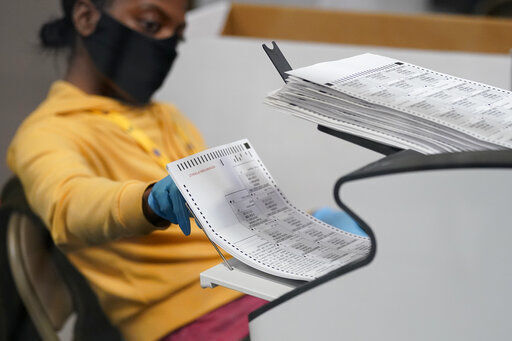 A county election worker scans mail-in ballots at a tabulating area at the Clark County Election Department, Thursday, Nov. 5, 2020, in Las Vegas. (AP Photo/John Locher) PHOTO CREDIT: John Locher