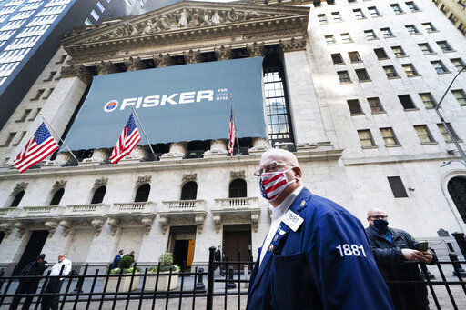 Stock trader Thomas Ferrigno arrives to work at the New York Stock Exchange. Stock markets rocketed higher today after Pfizer said early data show its coronavirus vaccine is effective and investors breathed a sigh of relief after days of U.S. presidential limbo ended with Democrat Joe Biden declared the president-elect. PHOTO CREDIT: Mark Lennihan