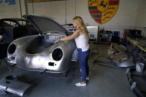 Laurina Esposito, co-owner of Espo Restoration, which specializes in restoring Porsches, inspects a frame at her shop in the North Hollywood section of Los Angeles. Esposito and her business partner were diagnosed with coronavirus in early September. She was very ill for three weeks and did as much work as she could on her laptop in bed, but at times was too exhausted.  PHOTO CREDIT: Marcio Jose Sanchez