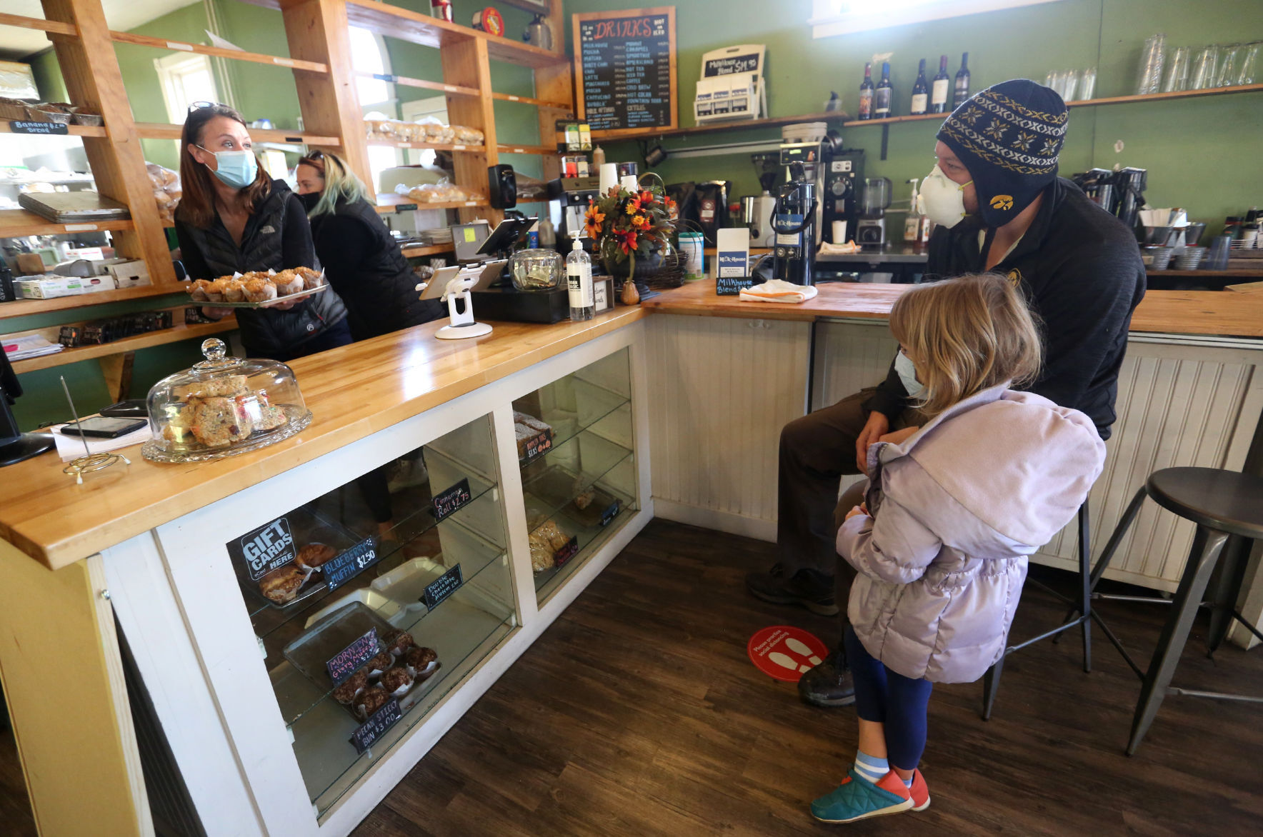 Owner Ali Fuller talks with Bob Heath and his daughter, Grace, 6, both of Dubuque, at Milk House Artisan Eatery, Baked Goods & Catering in Dubuque on Wednesday, Nov. 18, 2020. PHOTO CREDIT: JESSICA REILLY