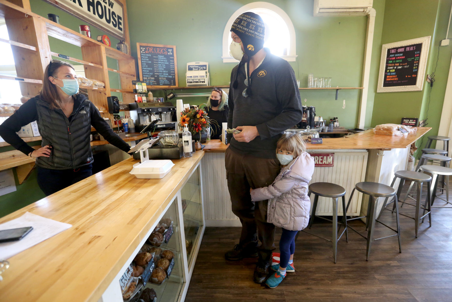 Owner Ali Fuller talks with Bob Heath and his daughter, Grace, 6, both of Dubuque, at Milk House Artisan Eatery, Baked Goods & Catering in Dubuque on Wednesday. PHOTO CREDIT: JESSICA REILLY