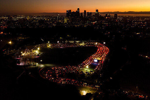 FILE - In this Nov 18, 2020, file photo, motorists wait in long lines to take a coronavirus test in a parking lot at Dodger Stadium in Los Angeles. With coronavirus cases surging and families hoping to gather safely for Thanksgiving, long lines to get tested have reappeared across the U.S. (AP Photo/Ringo H.W. Chiu, File) PHOTO CREDIT: Ringo H.W. Chiu
