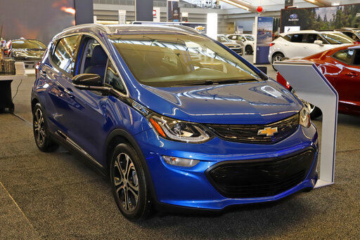 FILE - In this Feb. 13, 2020 file photo a 2020 Chevrolet Bolt EV is displayed at the 2020 Pittsburgh International Auto Show in Pittsburgh. On Thursday, Nov. 19, 2020, General Motors says a pending breakthrough in battery chemistry will cut the price of its electric vehicles so they equal those powered by gasoline within five years. (AP Photo/Gene J. Puskar, File) PHOTO CREDIT: Gene J. Puskar