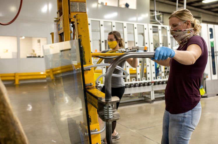 Emily Vorwald (left) and Melissa McLees construct glass dividers at Modernfold, in Dyersville, Iowa. The manufacturer began in 1925 in Indiana and gained fame at the 1939 World’s Fair. The Dyersville plant began in 1969 and has expanded since. PHOTO CREDIT: Jacob Fiscus