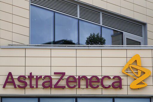 FILE - In this Saturday, July 18, 2020 file photo a general view of AstraZeneca offices and the corporate logo in Cambridge, England. AstraZeneca says late-stage trials of its COVID-19 vaccine were "highly effective