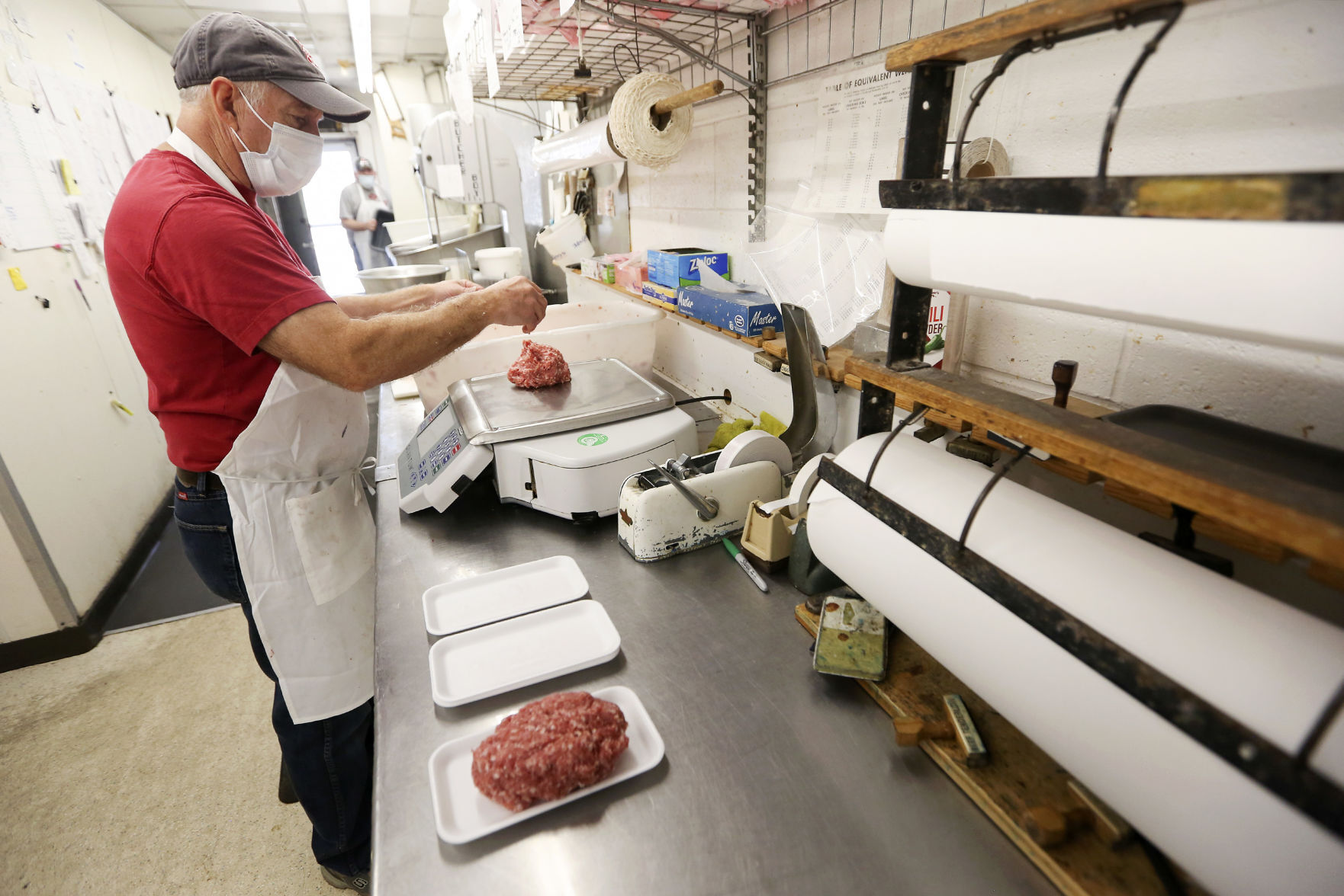 Ralph Roloff weighs pork sausage at Cremer