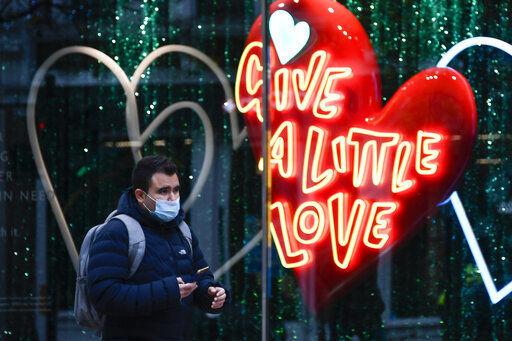 A man wears a face mask as he walks past a shop window in Oxford Street, in London, Tuesday, Nov. 24, 2020. Haircuts, shopping trips and visits to the pub will be back on the agenda for millions of people when a four-week lockdown in England comes to an end next week, British Prime Minister Boris Johnson said Monday. (AP Photo/Alberto Pezzali) PHOTO CREDIT: Alberto Pezzali