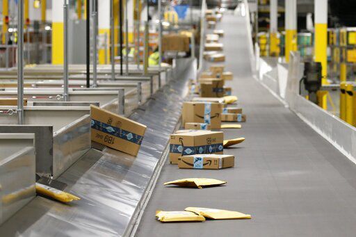 FILE - In this Dec. 17, 2019, file photo Amazon packages move along a conveyor at an Amazon warehouse facility in Goodyear, Ariz. In the years since Barack Obama and Joe Biden left the White House, the tech industry
