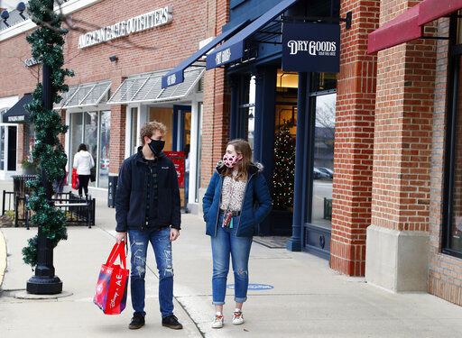 Andrew Czarnik, 17, and his sister Katherine Czarnik, 18, both of Deer Park, Ill., were happy to get good Black Friday deals at American Eagle Outfitters while shopping outdoors at Deer Park Town Center Friday, Nov. 27, 2020, in Deer Park, Ill. (Brian Hill/Daily Herald via AP) PHOTO CREDIT: Brian Hill