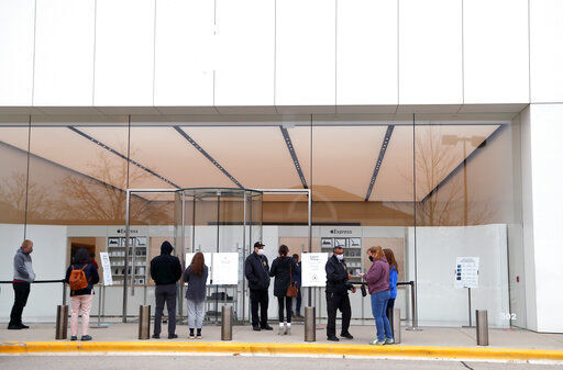 Customers wait to get into the Apple store for appointments during Black Friday shopping outdoors at Deer Park Town Center Friday, Nov. 27, 2020, in Deer Park, Ill. (Brian Hill/Daily Herald via AP) PHOTO CREDIT: Brian Hill