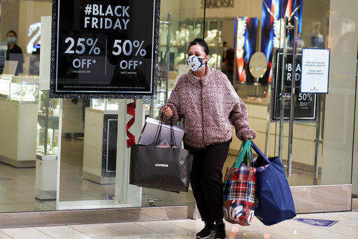 A Black Friday shopper wearing a face mask carries bags at the Glendale Galleria in Glendale, Calif., Friday, Nov. 27, 2020. (AP Photo/Ringo H.W. Chiu) PHOTO CREDIT: Ringo H.W. Chiu