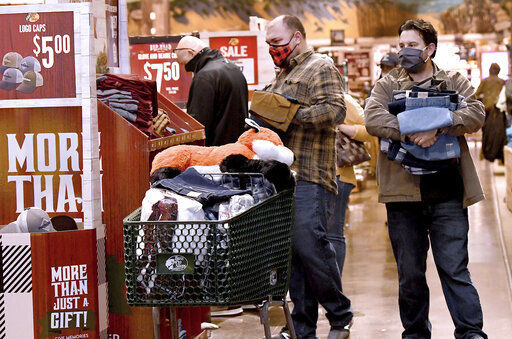 Shoppers get in on the Black Friday sales while shopping at Bass Pro Shops in Foxboro, Mass. Friday, Nov. 27, 2020. The outdoor specialty store opened their doors at 5 a.m. (Mark Stockwell /The Sun Chronicle via AP) PHOTO CREDIT: Mark Stockwell / The Sun Chronicle