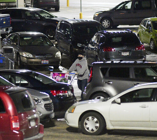 A Black Friday shopper negotiates the Walmart parking lot early Friday, Nov. 27, 2020, in Ashtabula Township, Ohio. (Warren Dillaway/The Star-Beacon via AP) PHOTO CREDIT: Warren Dillaway