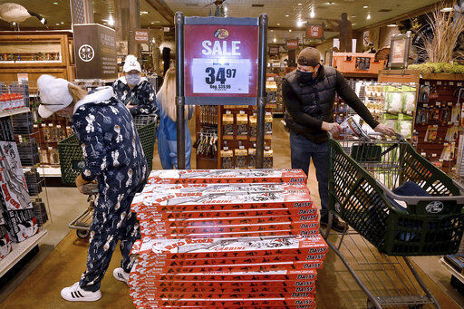 Tracy Ford and her sister Gwen Ford, at left, look over a display of Red Ryder Carbine Action BB guns during Black Friday sale at the Bass Pro Shops in Foxboro, Mass., Friday, Nov. 27, 2020. The outdoor specialty store opened their doors at 5 a.m. (Mark Stockwell /The Sun Chronicle via AP) PHOTO CREDIT: Mark Stockwell / The Sun Chronicle