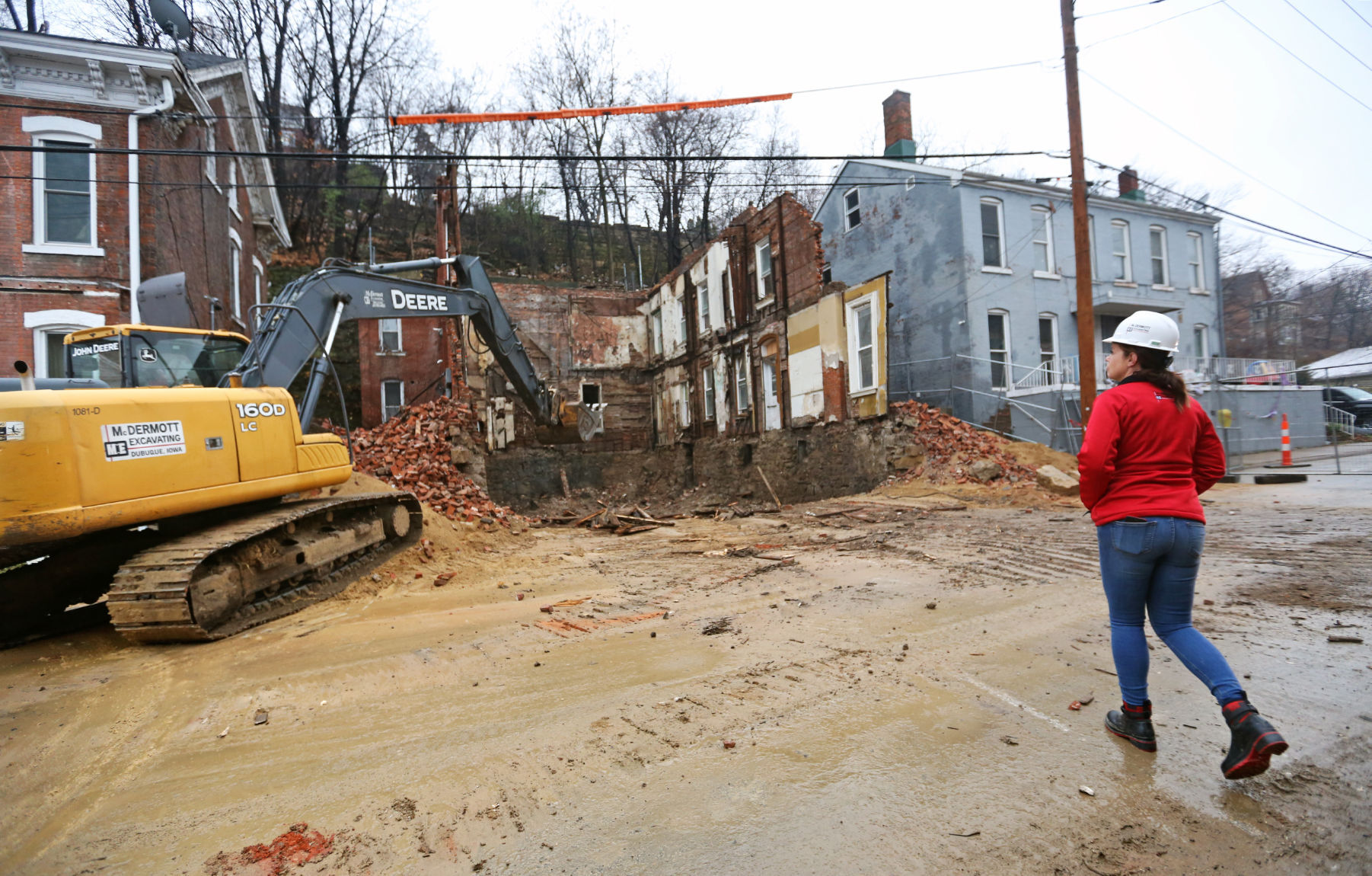 Tara Duggan, president and owner of McDermott Excavating, observes a job site at 1025 Bluff Street in Dubuque. PHOTO CREDIT: Jessica Reilly