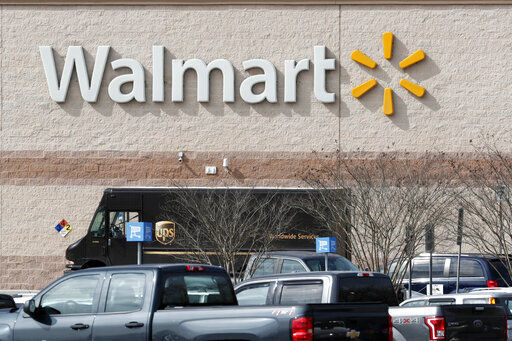 Walmart says for the fourth time during the pandemic it will give its 1.5 million U.S. part-time and full-time employees additional cash bonuses for their work. PHOTO CREDIT: Gerry Broome