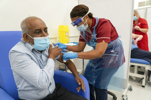 Care home worker Pillay Jagambrun, 61, receives the Pfizer/BioNTech COVID-19 vaccine in The Vaccination Hub at Croydon University Hospital, south London, on the first day of the largest immunization program in the UK