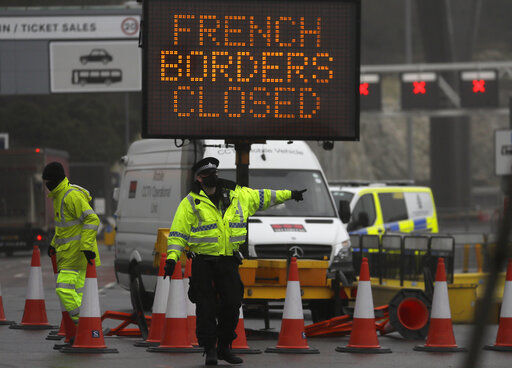A police officer directs traffic at the entrance to the closed ferry terminal in Dover, England, on Monday after the Port of Dover was closed and access to the Eurotunnel terminal suspended following the French government’s announcement. PHOTO CREDIT: Kirsty Wigglesworth, The Associated Press