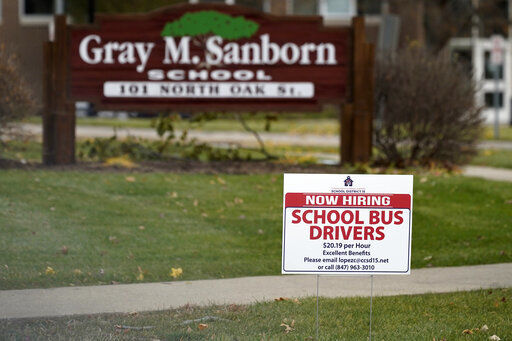 A hiring sign shows outside of Gray M. Sanborn Elementary School in Palatine, Ill., Thursday, Nov. 5, 2020. Illinois reports biggest spike in unemployment claims of all states. On Wednesday, Dec. 23, the number of Americans seeking unemployment benefits fell by 89,000 last week to a still-elevated 803,000, evidence that the job market remains under stress nine months after the coronavirus outbreak sent the U.S. economy into recession and caused millions of layoffs. (AP Photo/Nam Y. Huh) PHOTO CREDIT: Nam Y. Huh