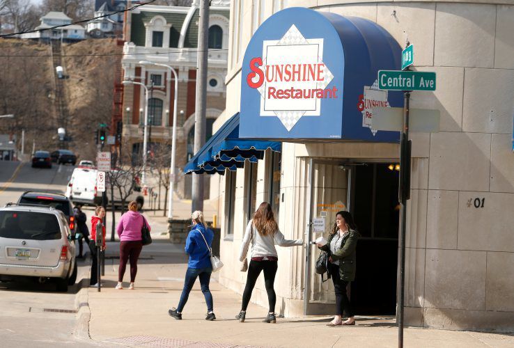 People exit Sunshine Restaurant in downtown Dubuque before noon on March 17. Iowa Gov. Kim Reynolds declared a “public health disaster emergency” that morning and ordered the closure at noon of the state’s bars and dine-in services at restaurants in a bid to slow the spread of coronavirus. Many restaurants endured closures or reduced capacities in 2020. PHOTO CREDIT: Dave Kettering, Telegraph Herald