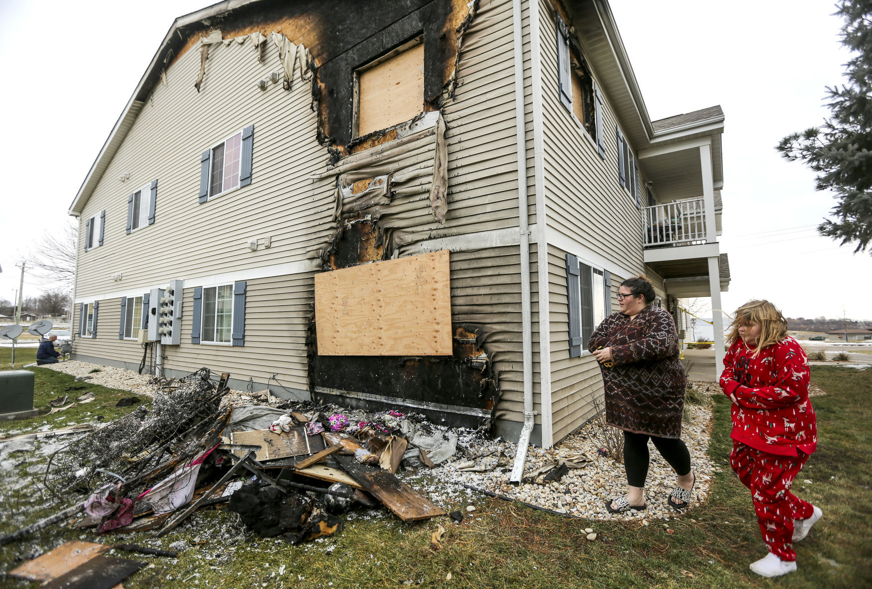 Amber Droessler and her daughter Billie Jean Shaffer, 10, look at the damage to their apartment, which is located directly beneath a unit that had a fire Tuesday night in Cuba City, Wis. PHOTO CREDIT: Dave Kettering