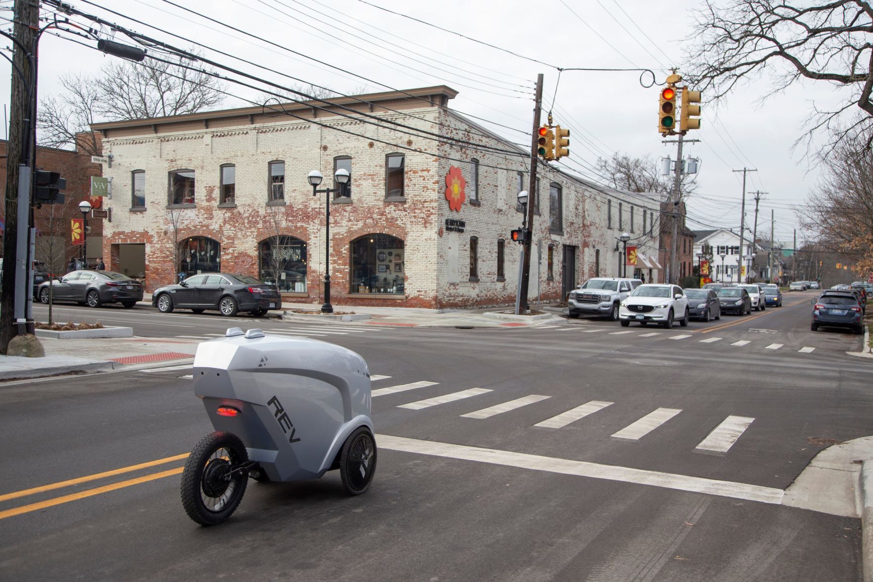 Refraction AI in Ann Arbor has developed an autonomous delivery robot. The first generation Rev1 sits at a red light in Kerrytown while on a mission to deliver sandwiches in downtown Ann Arbor.  PHOTO CREDIT: Tribune News Service