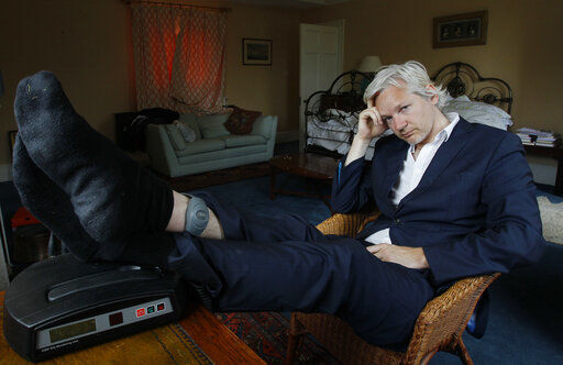 FILE - In this Wednesday, June 15, 2011 file photo, WikiLeaks founder Julian Assange is seen with his ankle security tag at the house where he is required to stay, near Bungay, England. Judge Vanessa Baraitser has ruled that Julian Assange cannot be extradited to the US. because of concerns about his mental health, it was reported on Monday, Jan. 4, 2021. Assange had been charged under the US