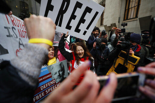 Julian Assange supporters celebrate after a ruling that he cannot be extradited to the United States, outside the Old Bailey in London, Monday, Jan. 4, 2021. A British judge has rejected the United States