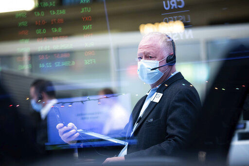 In this photo provided by the New York Stock Exchange, trader Robert Moran works on the floor, Tuesday, Jan. 5, 2021. U.S. stocks are wobbling between small gains and losses on Tuesday, a day after dropping to their worst loss in months amid the worsening pandemic and potentially market-moving Senate elections. (Colin Ziemer/New York Stock Exchange via AP) PHOTO CREDIT: Colin Ziemer